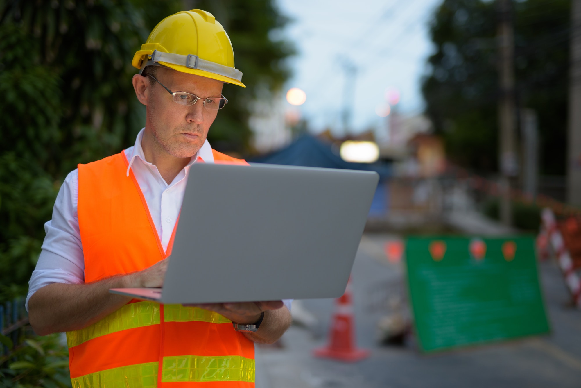 Mature man construction worker at the construction site in the c